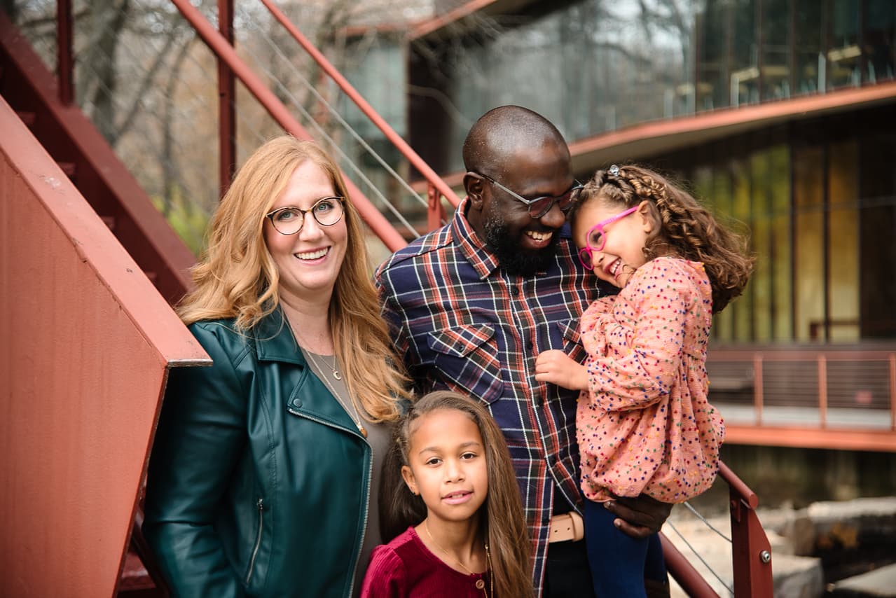 Family laughing together outdoors during a fall session